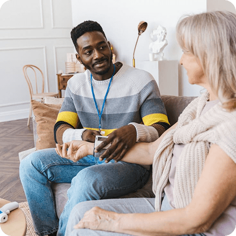 A carer supporting an older woman at home